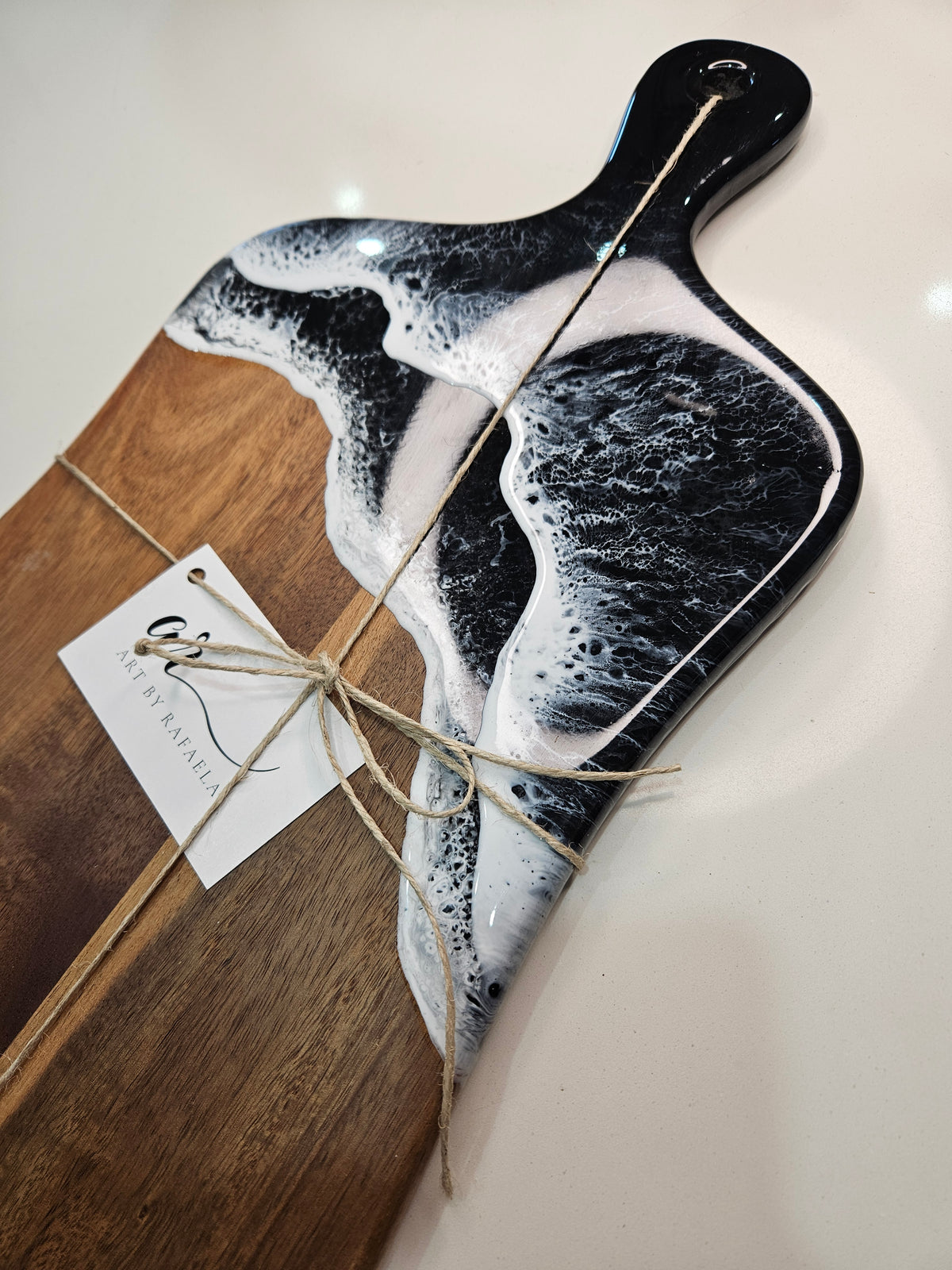 Hand-poured resin and hardwood cheese board by Art by Rafaela with black ocean waves and white seafoam — handmade Australian art homewares