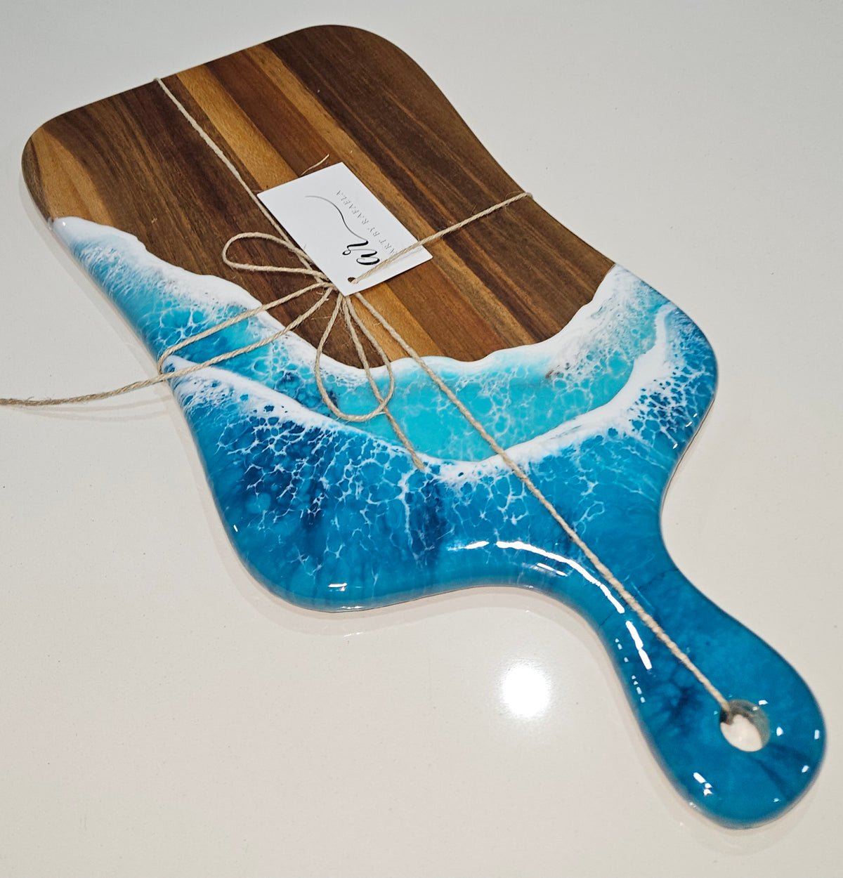 Hand-poured resin and hardwood cheese board by Art by Rafaela with turquoise ocean waves — handmade Australian coastal homewares